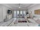 Bright living room with white sectional sofa and large windows at 424 Luna Bella Ln # 222, New Smyrna Beach, FL 32168