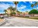Gated entrance to a condo community with palm trees and well-maintained landscaping at 424 Luna Bella Ln # 222, New Smyrna Beach, FL 32168