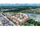 Aerial view of condo community near lake, highlighting building location and surrounding landscape at 424 Luna Bella Ln # 222, New Smyrna Beach, FL 32168