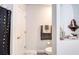 Small bathroom with toilet, shower, and decorative shelving at 424 Luna Bella Ln # 222, New Smyrna Beach, FL 32168