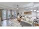 Spacious living room with white sectional sofa and access to a balcony at 424 Luna Bella Ln # 222, New Smyrna Beach, FL 32168