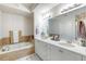 Double vanity bathroom with soaking tub and walk-in shower at 424 Luna Bella Ln # 222, New Smyrna Beach, FL 32168