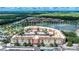 Aerial view of condo community near lake, showcasing building location and surrounding landscape at 424 Luna Bella Ln # 222, New Smyrna Beach, FL 32168