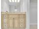 Light wood vanity with granite countertop in bathroom at 2200 N Atlantic Ave # 1602, Daytona Beach, FL 32118