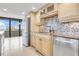 Modern kitchen with light wood cabinets, granite counters, and ocean view at 2200 N Atlantic Ave # 1602, Daytona Beach, FL 32118