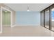 Spacious living room with light blue accent wall and ocean views at 2200 N Atlantic Ave # 1602, Daytona Beach, FL 32118