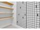 Condo features a storage room with shelving and a grid wall at 2200 N Atlantic Ave # 1602, Daytona Beach, FL 32118