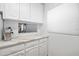Kitchen features white cabinets, quartz countertops, and a coffee bar at 1510 Ocean Shore Blvd # 3150, Ormond Beach, FL 32176
