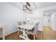 Dining area with a white table and gray chairs, along with shiplap walls at 1510 Ocean Shore Blvd # 3150, Ormond Beach, FL 32176