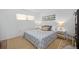 King-size bed, gray bedding, and coastal-themed artwork in bedroom at 1510 Ocean Shore Blvd # 3150, Ormond Beach, FL 32176
