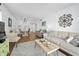 Living room with light and airy decor, a comfortable sofa, and wood-look floors at 1510 Ocean Shore Blvd # 3150, Ormond Beach, FL 32176