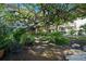 Peaceful garden with a large tree, brick pathway, and lush vegetation at 1510 Ocean Shore Blvd # 3150, Ormond Beach, FL 32176