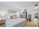 Spacious bedroom with king-size bed, gray bedding, and coastal decor at 1510 Ocean Shore Blvd # 3150, Ormond Beach, FL 32176