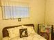 Cozy bedroom with a comfortable bed and window at 216 Rue De Paresse, Tavares, FL 32778