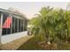 Landscaped front yard with palm tree and American flag at 216 Rue De Paresse, Tavares, FL 32778