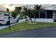 Single-wide mobile home with carport and nicely landscaped yard at 216 Rue De Paresse, Tavares, FL 32778