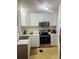 Modern kitchen with stainless steel appliances and white cabinets at 216 Rue De Paresse, Tavares, FL 32778
