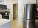 Modern kitchen with stainless steel appliances and white cabinets at 216 Rue De Paresse, Tavares, FL 32778
