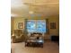 Bright living room featuring comfortable seating and large windows at 216 Rue De Paresse, Tavares, FL 32778