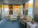 Relaxing sunroom with wicker furniture and view of the park at 216 Rue De Paresse, Tavares, FL 32778