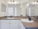 Double vanity bathroom with granite countertops and large mirrors at 280 Celebration Blvd # 203, Celebration, FL 34747