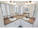 Double vanity bathroom with granite countertops and updated fixtures at 280 Celebration Blvd # 203, Celebration, FL 34747