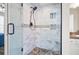 Large walk-in shower with pebble floor and marble tile at 280 Celebration Blvd # 203, Celebration, FL 34747