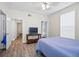 Spacious bedroom with wood floors and access to other rooms at 280 Celebration Blvd # 203, Celebration, FL 34747