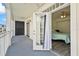 Bedroom with access to a private balcony overlooking a treetop view at 280 Celebration Blvd # 203, Celebration, FL 34747