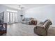 Spacious living room with hardwood floors and access to a balcony at 280 Celebration Blvd # 203, Celebration, FL 34747