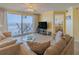 Bright living room boasts ocean views, comfy seating, and access to a balcony at 1183 Ocean Shore Blvd # 6040, Ormond Beach, FL 32176