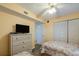 Guest bedroom with twin beds and dresser at 1183 Ocean Shore Blvd # 6040, Ormond Beach, FL 32176