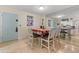Dining area with a table, chairs, and view into the living room and kitchen at 1415 Ocean Shore Blvd # B030, Ormond Beach, FL 32176
