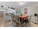 Dining area with a table, chairs, and view into the living room and kitchen at 1415 Ocean Shore Blvd # B030, Ormond Beach, FL 32176