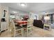 Dining area with a table, chairs, and view into the living room and kitchen at 1415 Ocean Shore Blvd # B030, Ormond Beach, FL 32176