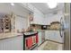Kitchen with white cabinets, granite countertops, and stainless steel appliances at 1415 Ocean Shore Blvd # B030, Ormond Beach, FL 32176