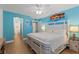 Bright main bedroom with king-size bed and ensuite bathroom at 1415 Ocean Shore Blvd # B030, Ormond Beach, FL 32176