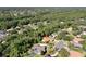 An aerial view of a house nestled in a quiet, tree-filled neighborhood at 3404 Rexford Cir, Ormond Beach, FL 32174