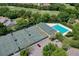 Aerial view of tennis courts, pool, and parking area at 3404 Rexford Cir, Ormond Beach, FL 32174