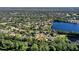 Aerial view of a house by a lake in a residential area at 3404 Rexford Cir, Ormond Beach, FL 32174