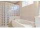 Bathroom with soaking tub, glass block shower, and tile flooring at 3404 Rexford Cir, Ormond Beach, FL 32174