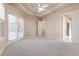 Large bedroom with plush carpet, French doors, and ample natural light at 3404 Rexford Cir, Ormond Beach, FL 32174