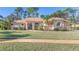Single-story home with stucco exterior, tile roof, and lush landscaping at 3404 Rexford Cir, Ormond Beach, FL 32174