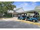 Golf cart storage area with several carts parked outside clubhouse at 3404 Rexford Cir, Ormond Beach, FL 32174