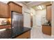Kitchen features granite counters, stainless steel fridge, and ample storage at 3404 Rexford Cir, Ormond Beach, FL 32174