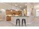 Kitchen features a breakfast bar with two stools and light wood cabinets at 3404 Rexford Cir, Ormond Beach, FL 32174
