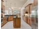 Open kitchen with large island, granite counters, and wood cabinets at 3404 Rexford Cir, Ormond Beach, FL 32174