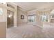 Open living area with tile and carpet flooring, and access to the backyard at 3404 Rexford Cir, Ormond Beach, FL 32174