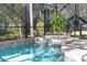 Relaxing screened pool and spa with lush greenery at 3404 Rexford Cir, Ormond Beach, FL 32174