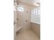 Walk-in shower with tile surround and built-in seat at 3404 Rexford Cir, Ormond Beach, FL 32174